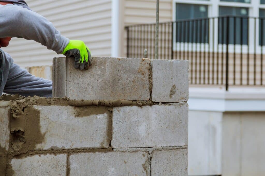 Construction Worker Building a Cinder Block Wall