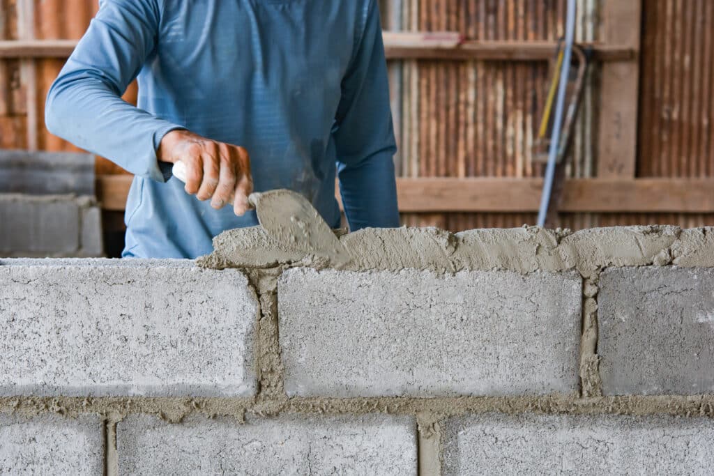 Construction Worker Building a Concrete Block Wall